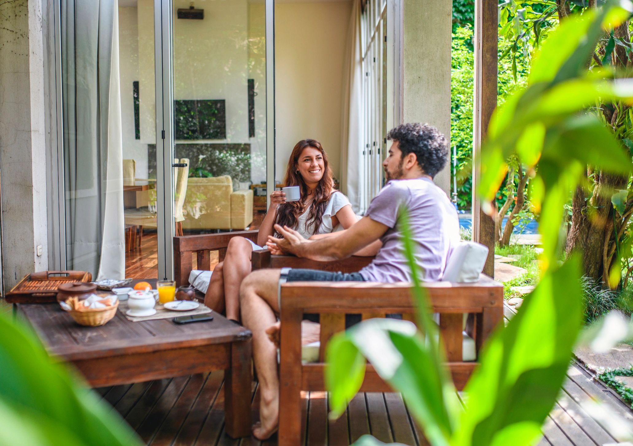 Relaxed conversation over coffee on a terrace
