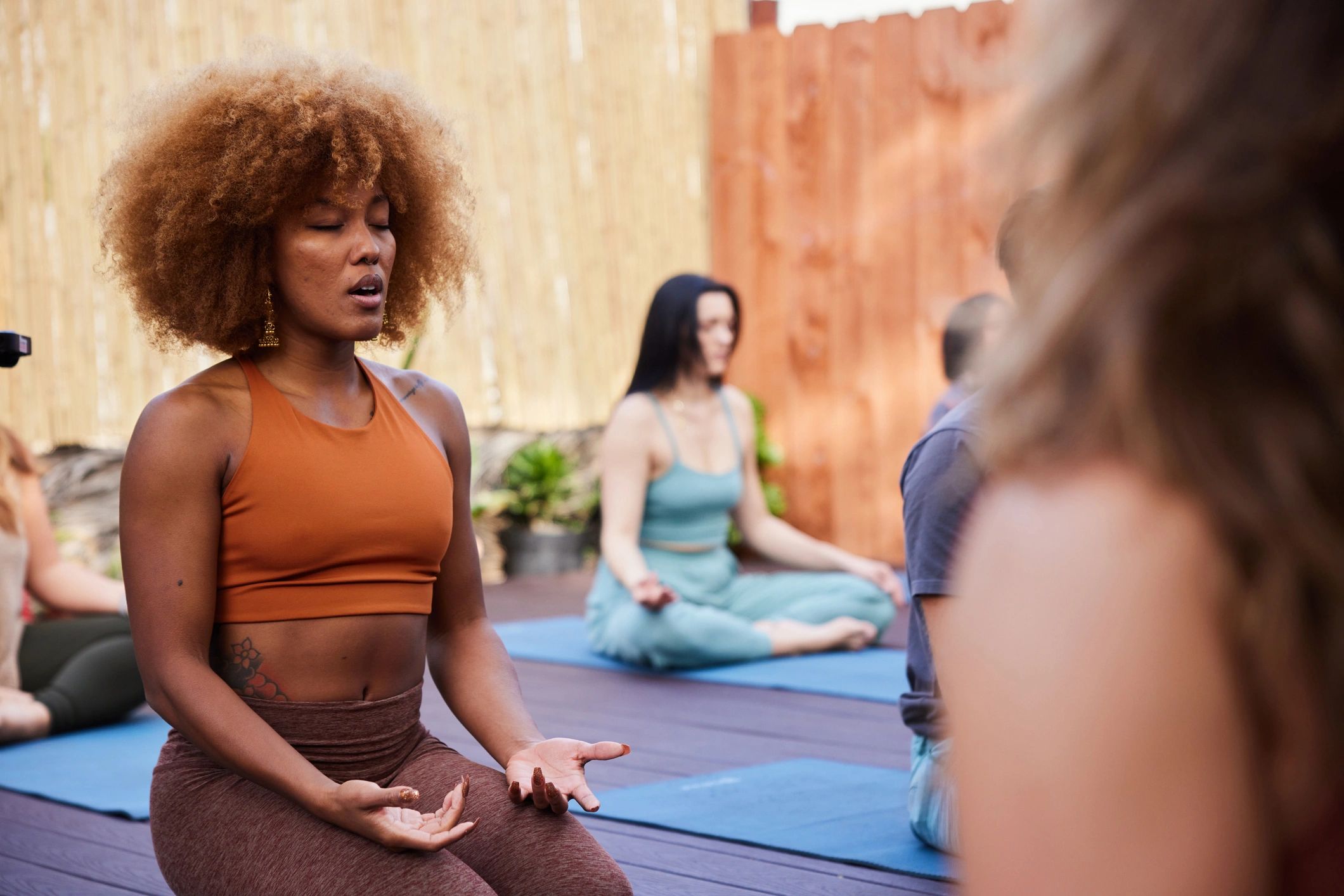 Group meditating outdoors during a wellness retreat