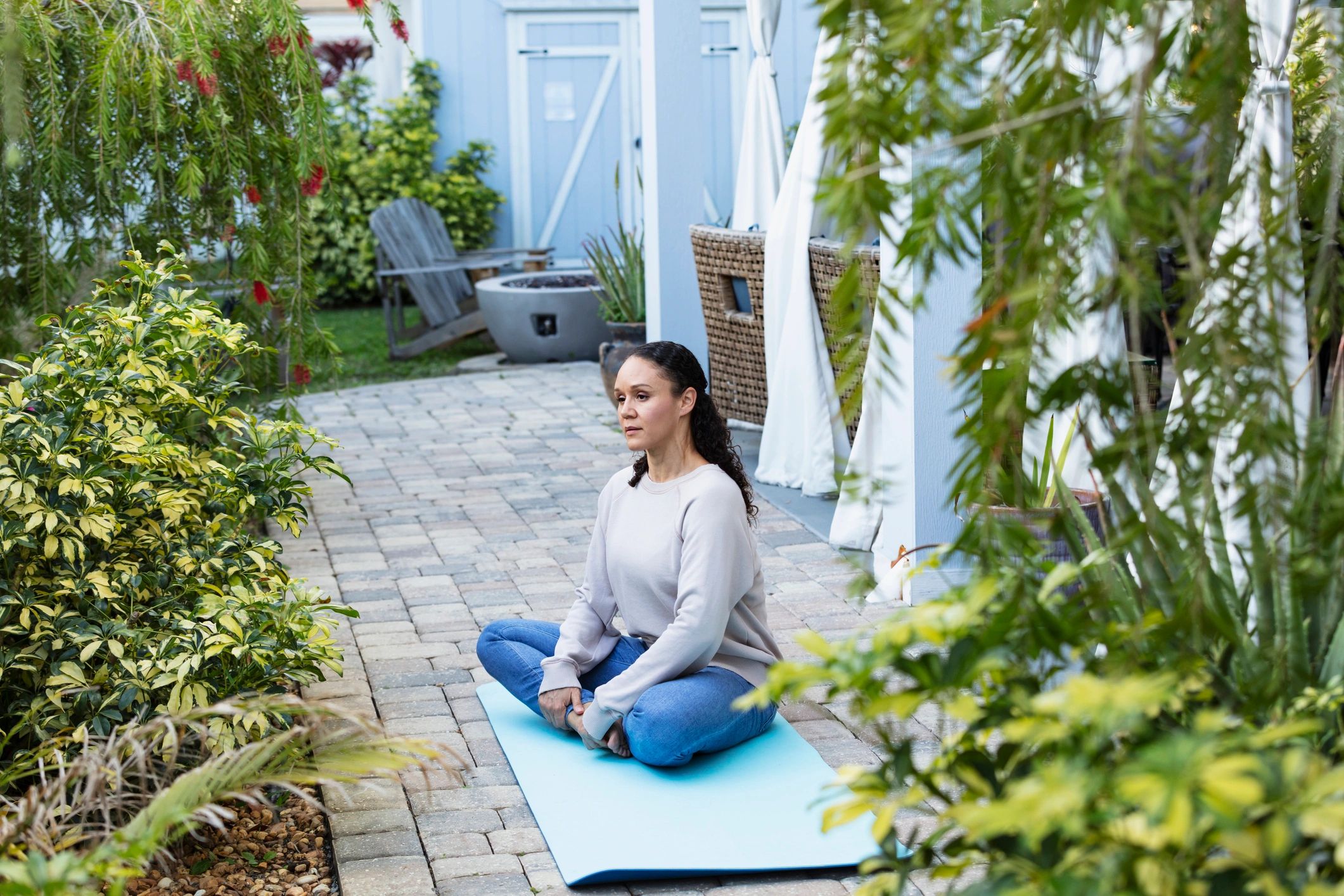 Mature woman meditating on a quiet patio