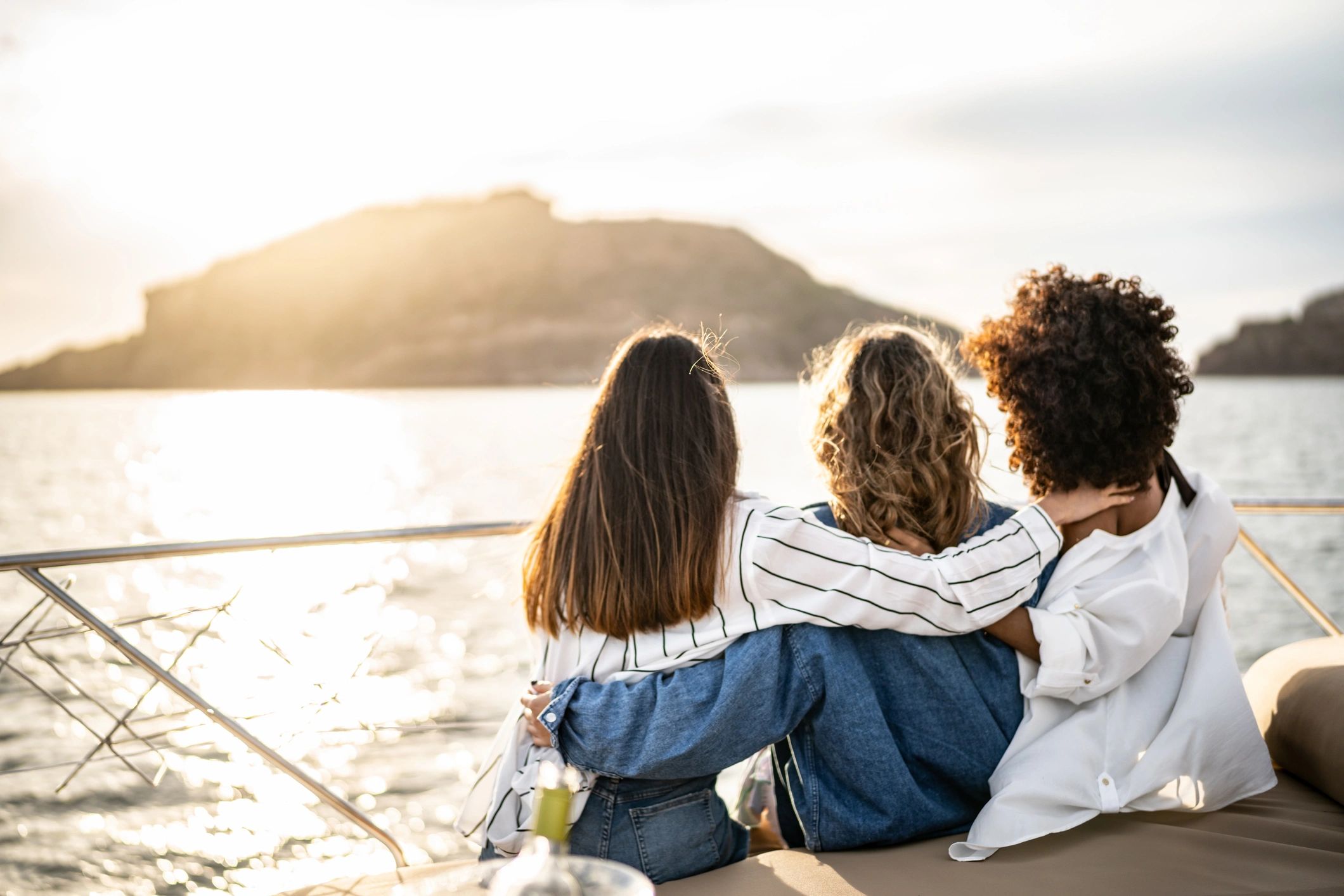 Friends enjoying sunset on a yacht deck