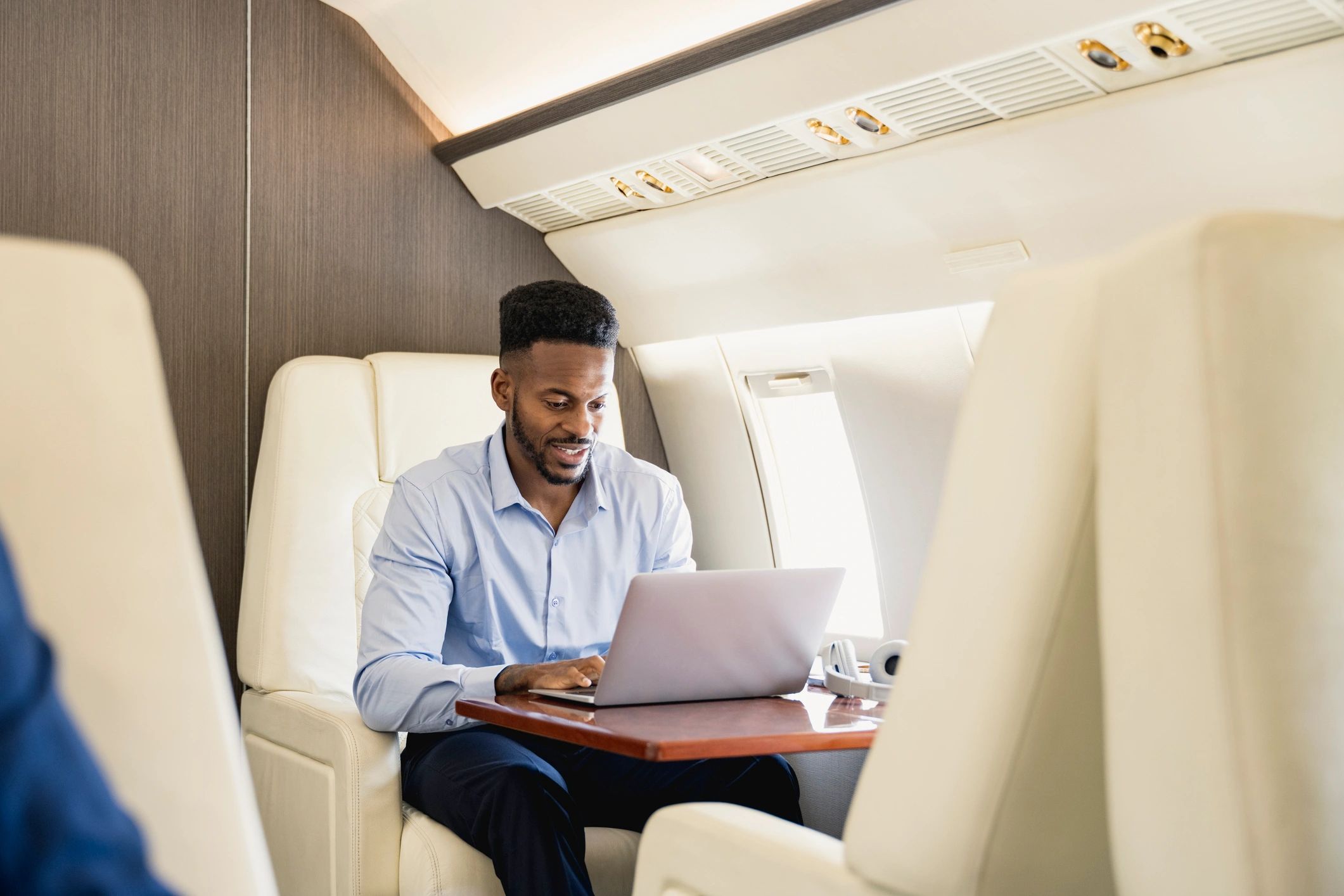 Businessman using laptop on a private jet