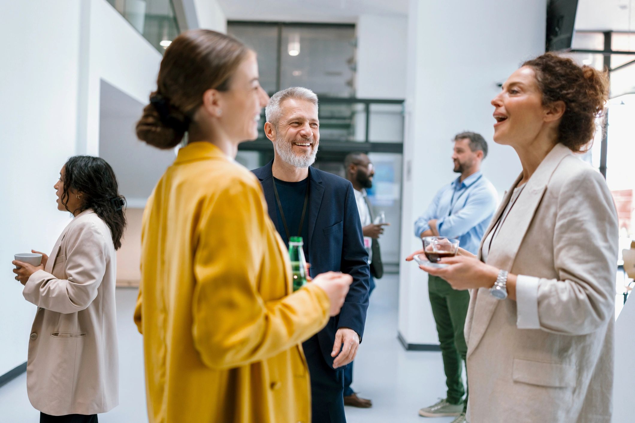 Professionals in quiet conversation during a workshop break