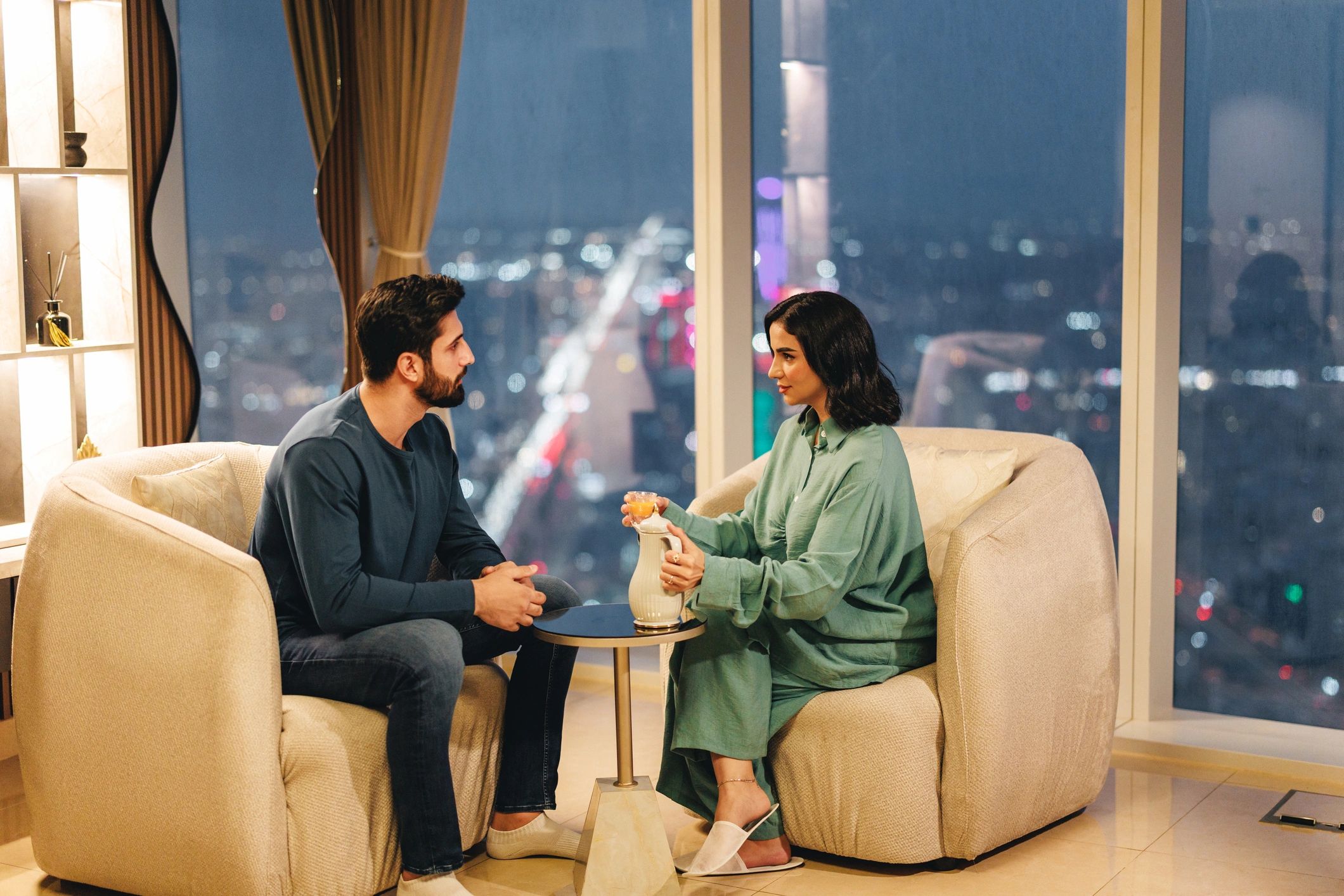Couple in a refined lounge setting having a private conversation