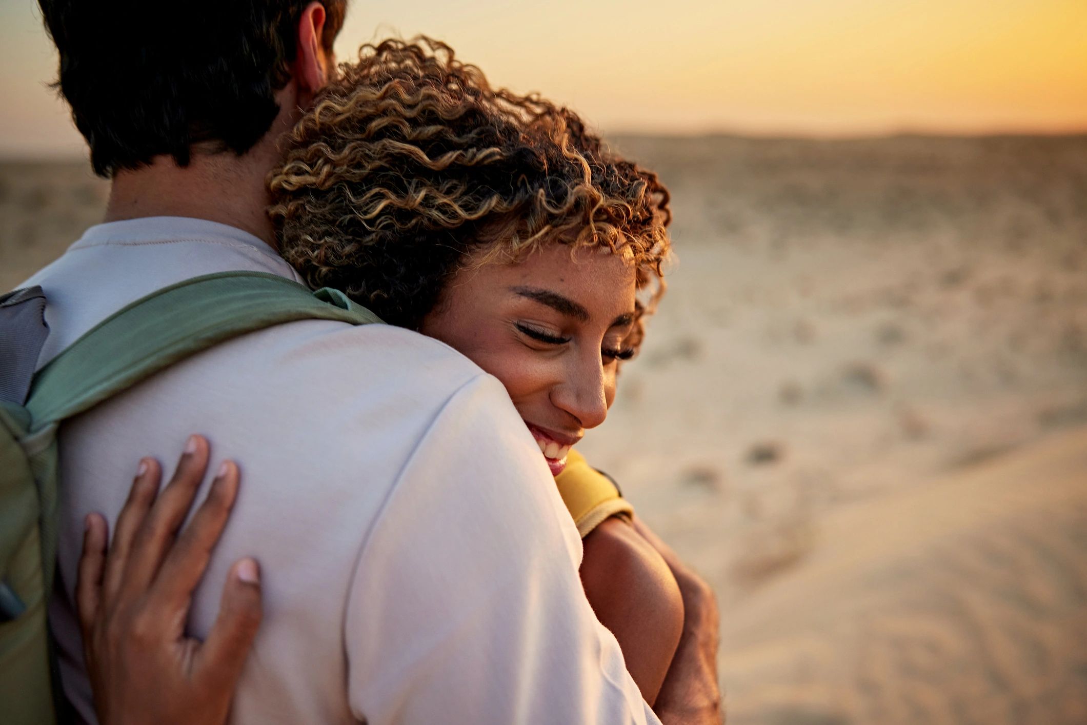 Couple embracing at sunset in a quiet landscape
